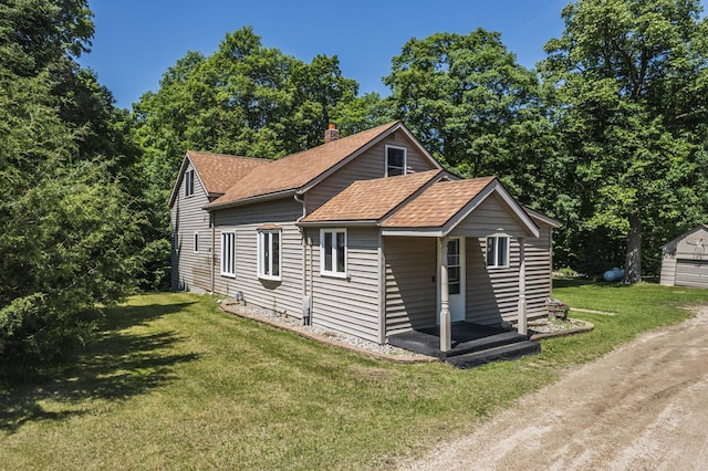 49227 US Highway 59, Dunn Twp, MN 56587 - view of front of property with a shingled roof, a front yard, and a chimney
