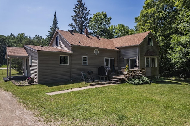 49227 US Highway 59, Dunn Twp, MN 56587 - back of house with a yard, a wooden deck, a chimney, and roof with shingles