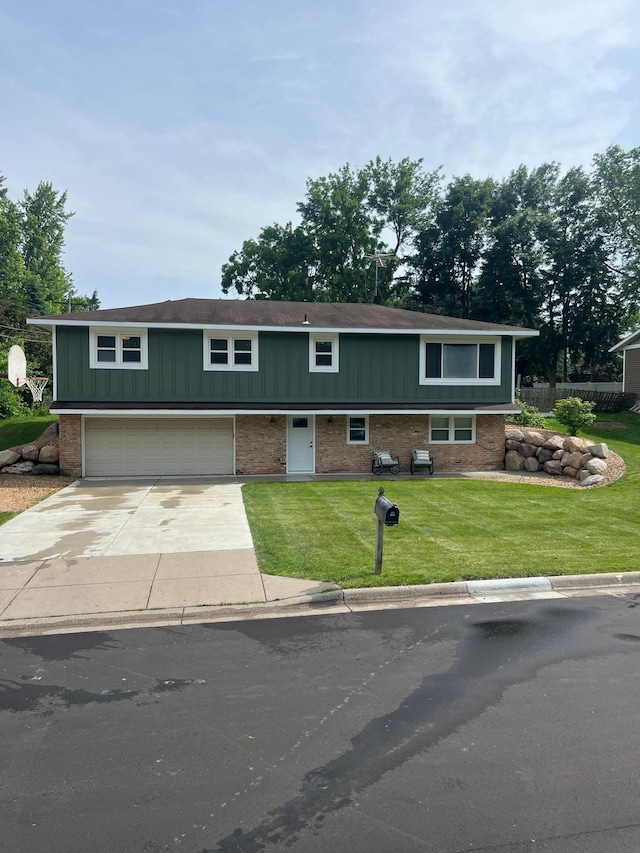 1307 20th St W, Hastings, MN 55033 - view of front of property featuring brick siding, a garage, concrete driveway, and a front lawn