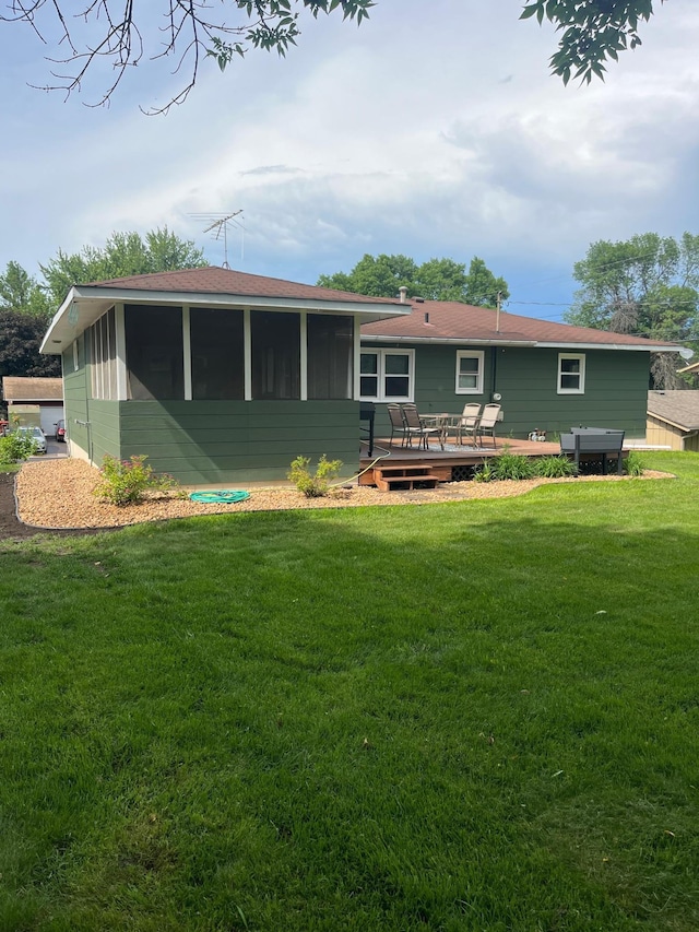 1307 20th St W, Hastings, MN 55033 - back of property featuring a wooden deck, a sunroom, a yard, and a shingled roof