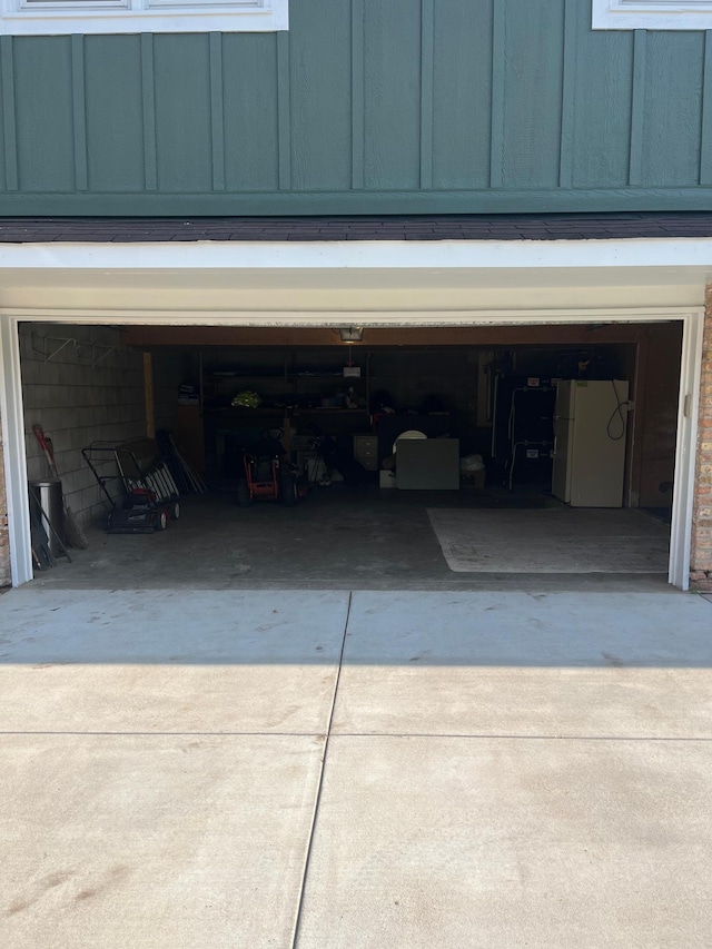 1307 20th St W, Hastings, MN 55033 - garage with driveway and freestanding refrigerator