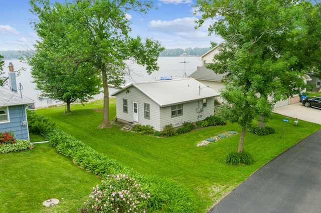 24186 Geldners Ln, Elysian Twp, MN 56017 - view of side of property with a yard, a water view, and a metal roof
