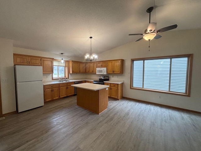 809 Aspen Cir, Waite Park, MN 56387 - kitchen featuring white appliances, light countertops, ceiling fan, light wood-style flooring, and vaulted ceiling