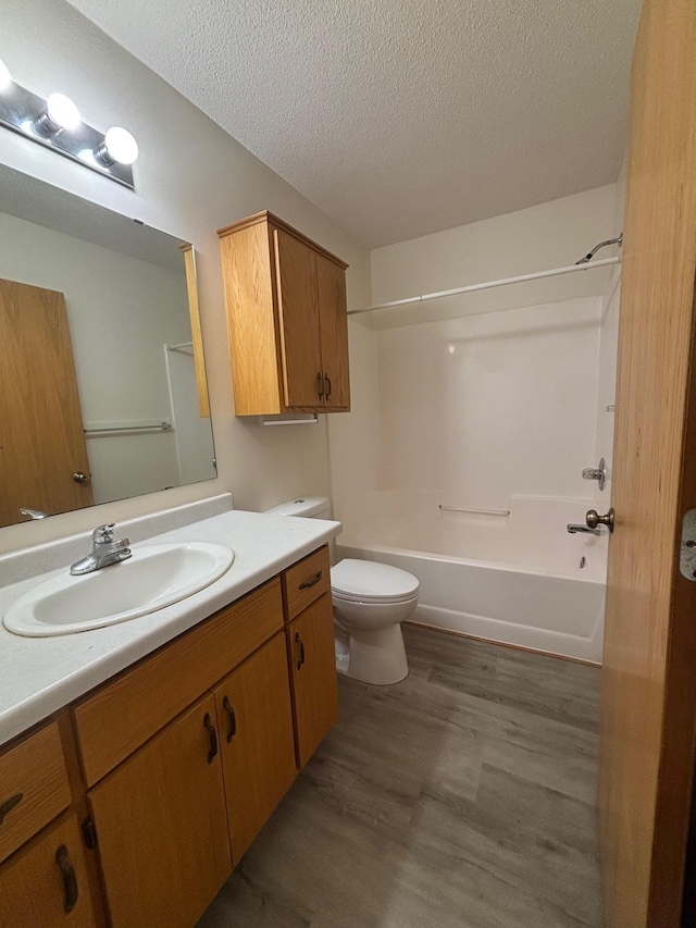 809 Aspen Cir, Waite Park, MN 56387 - full bathroom featuring vanity, a textured ceiling, wood finished floors, and bathtub / shower combination