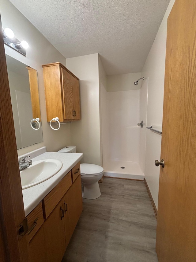 809 Aspen Cir, Waite Park, MN 56387 - full bath with vanity, a shower, wood finished floors, and a textured ceiling
