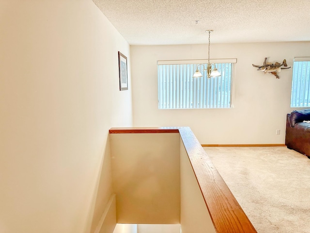 9100 Terra Verde Trl, Eden Prairie, MN 55347 - staircase with carpet floors, a textured ceiling, and a chandelier