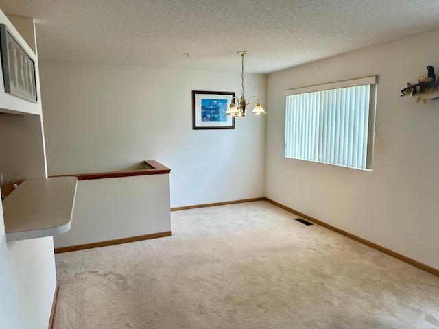 9100 Terra Verde Trl, Eden Prairie, MN 55347 - carpeted spare room with a chandelier and a textured ceiling