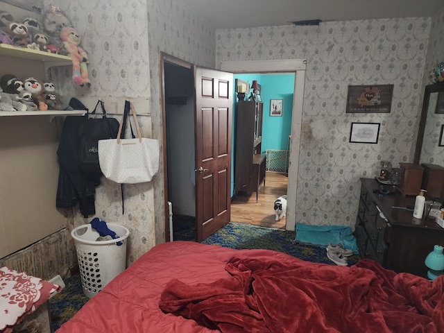 105 Main St, Brownsdale, MN 55918 - bedroom featuring wallpapered walls and wood finished floors