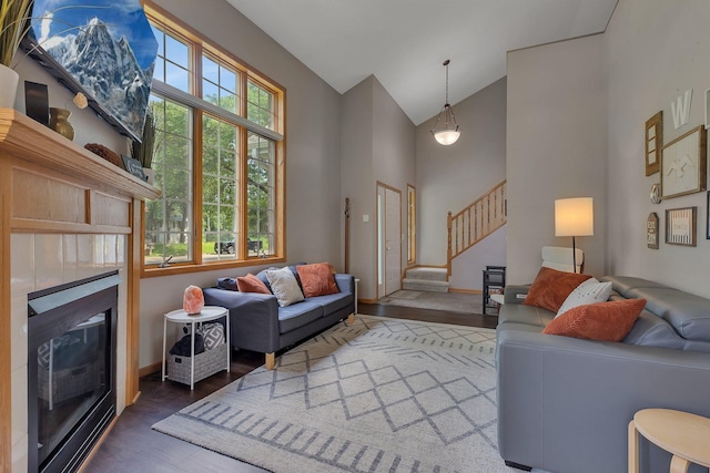 504 3rd St N, Sartell, MN 56377 - living area with wood finished floors, stairs, high vaulted ceiling, and a glass covered fireplace