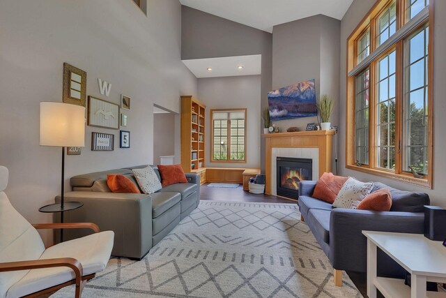 504 3rd St N, Sartell, MN 56377 - living area with a high ceiling, a tiled fireplace, and wood finished floors