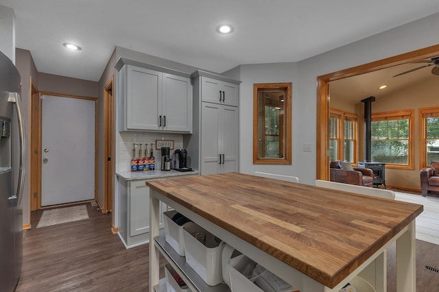 504 3rd St N, Sartell, MN 56377 - kitchen featuring a wood stove, wooden counters, dark wood-style flooring, recessed lighting, and stainless steel fridge with ice dispenser