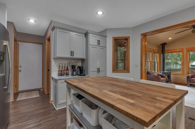 504 3rd St N, Sartell, MN 56377 - kitchen featuring a wood stove, wooden counters, dark wood-style floors, recessed lighting, and open floor plan