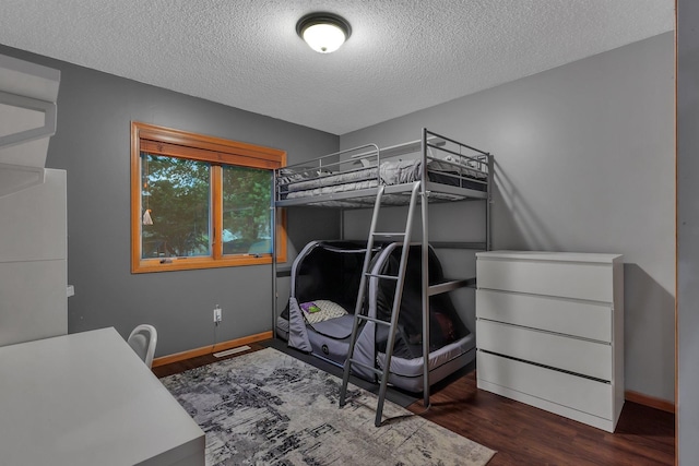 504 3rd St N, Sartell, MN 56377 - bedroom with a textured ceiling and wood finished floors