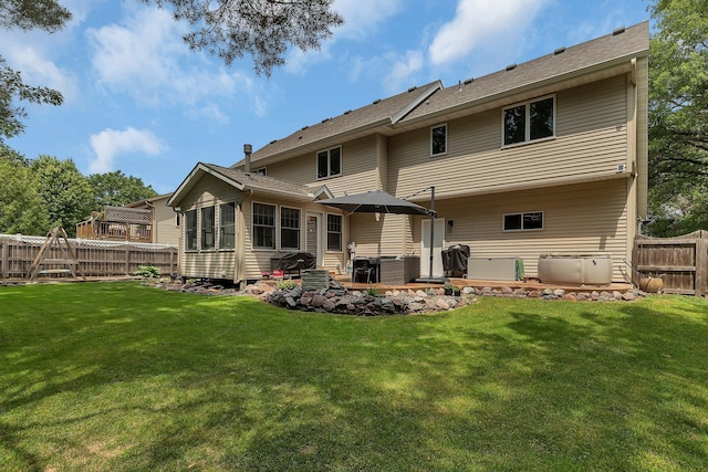 504 3rd St N, Sartell, MN 56377 - rear view of property with a fenced backyard and a patio