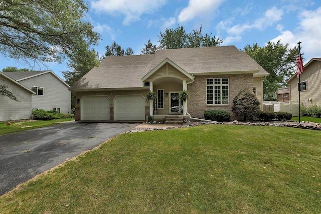 504 3rd St N, Sartell, MN 56377 - view of front facade with an attached garage, brick siding, driveway, a front yard, and roof with shingles