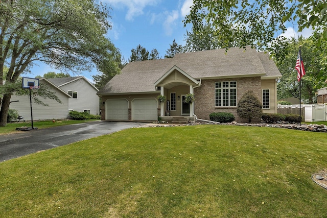 504 3rd St N, Sartell, MN 56377 - view of front of house featuring a garage, asphalt driveway, roof with shingles, and brick siding