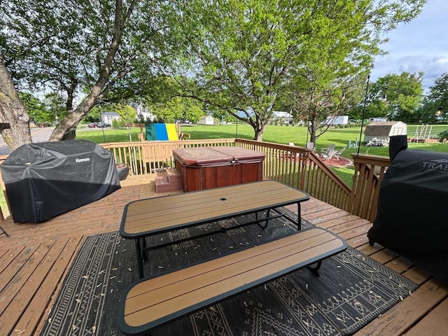 605 Park Island Dr SW, Hutchinson, MN 55350 - wooden deck with a hot tub, area for grilling, a lawn, and outdoor dining space