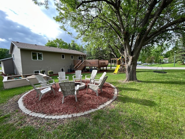 605 Park Island Dr SW, Hutchinson, MN 55350 - view of green lawn with a playground, a deck, a fire pit, and stairway