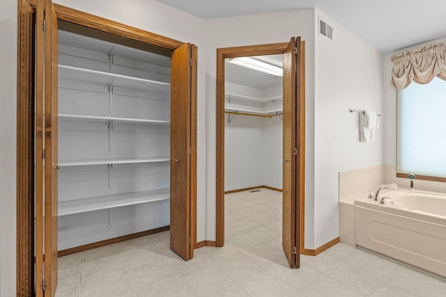 19800 Stephan Dr, Minnewaska Twp, MN 56381 - bathroom featuring a bath and a spacious closet