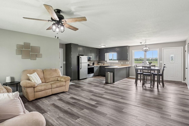 559 State Highway 35, East Farmington, WI 54020 - living room with dark wood-style floors, a ceiling fan, a textured ceiling, and a chandelier