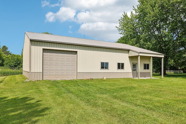 559 State Highway 35, East Farmington, WI 54020 - view of home's exterior with an outbuilding, a detached garage, a metal roof, and a lawn