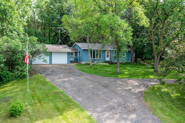 8545 70th St NW, Annandale, MN 55302 - ranch-style home featuring driveway, an attached garage, a front yard, and a shingled roof