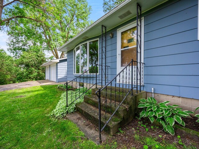8545 70th St NW, Annandale, MN 55302 - property entrance with a garage and a lawn