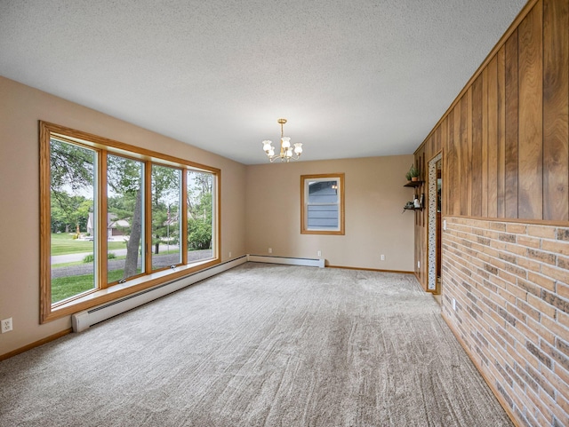 8545 70th St NW, Annandale, MN 55302 - spare room with a chandelier, light carpet, a textured ceiling, and a baseboard heating unit
