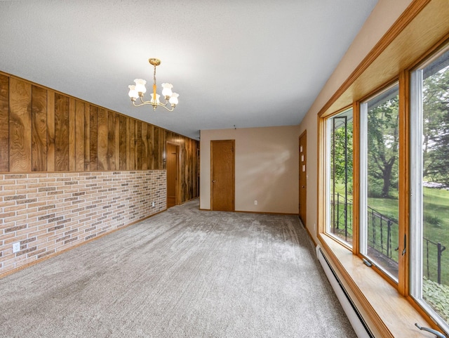 8545 70th St NW, Annandale, MN 55302 - unfurnished living room with baseboard heating, a chandelier, light colored carpet, and brick wall
