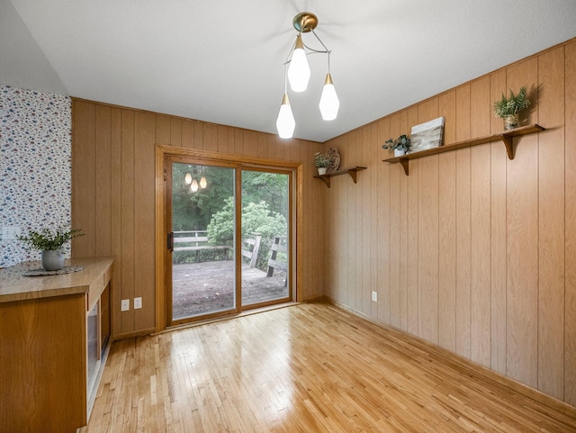 8545 70th St NW, Annandale, MN 55302 - unfurnished dining area with light wood-style floors and wooden walls