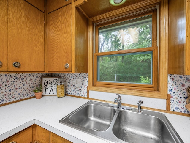 8545 70th St NW, Annandale, MN 55302 - kitchen with light countertops, brown cabinets, and wallpapered walls