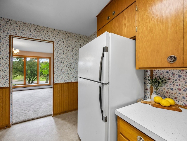 8545 70th St NW, Annandale, MN 55302 - kitchen with freestanding refrigerator, a wainscoted wall, wallpapered walls, brown cabinets, and light countertops