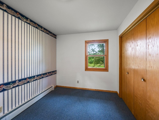 8545 70th St NW, Annandale, MN 55302 - unfurnished bedroom featuring a baseboard radiator, carpet, and a closet