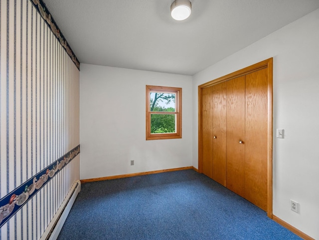 8545 70th St NW, Annandale, MN 55302 - unfurnished bedroom with carpet flooring, a closet, and a baseboard heating unit