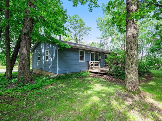 8545 70th St NW, Annandale, MN 55302 - rear view of house with a wooden deck and a lawn