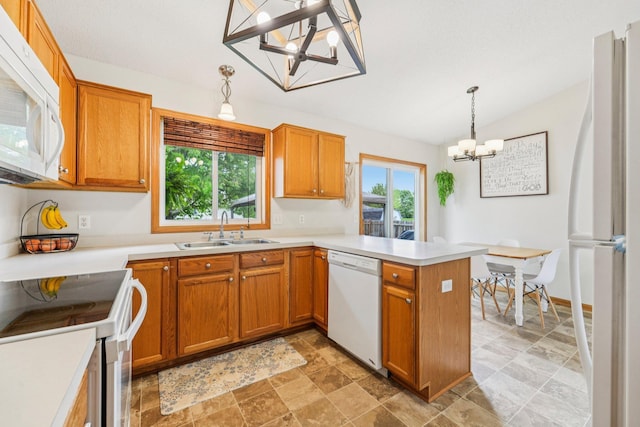 608 Frontier Cir, Belle Plaine, MN 56011 - kitchen featuring white appliances, a chandelier, a peninsula, vaulted ceiling, and brown cabinets