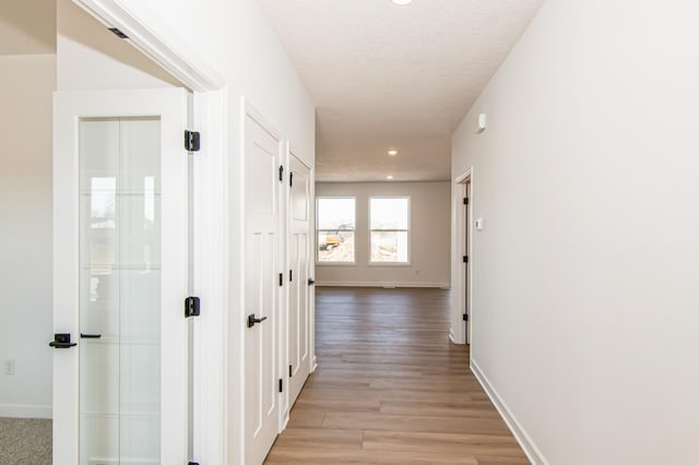 18665 Kennedy St NW, Elk River, MN 55330 - hallway with light wood-style flooring and recessed lighting