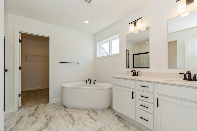 18665 Kennedy St NW, Elk River, MN 55330 - full bathroom featuring marble look tile flooring, double vanity, a soaking tub, a shower with door, and a walk in closet