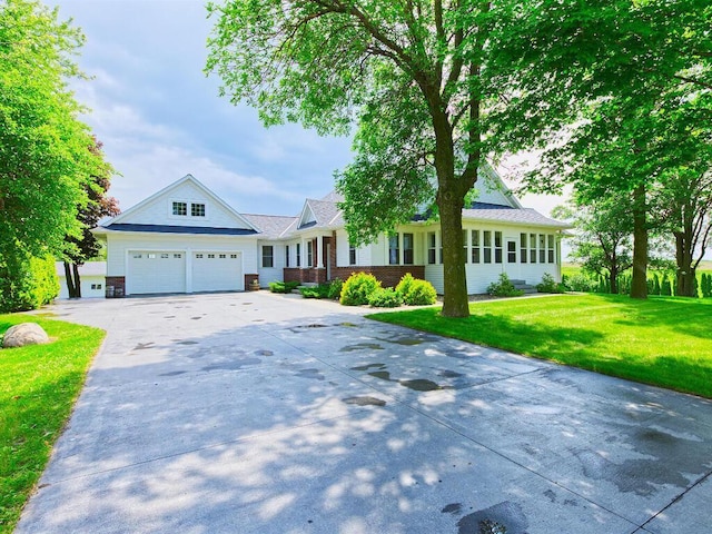 6828 Rhoades Ave SW, Cokato, MN 55321 - view of front facade with concrete driveway, a front yard, a garage, and brick siding