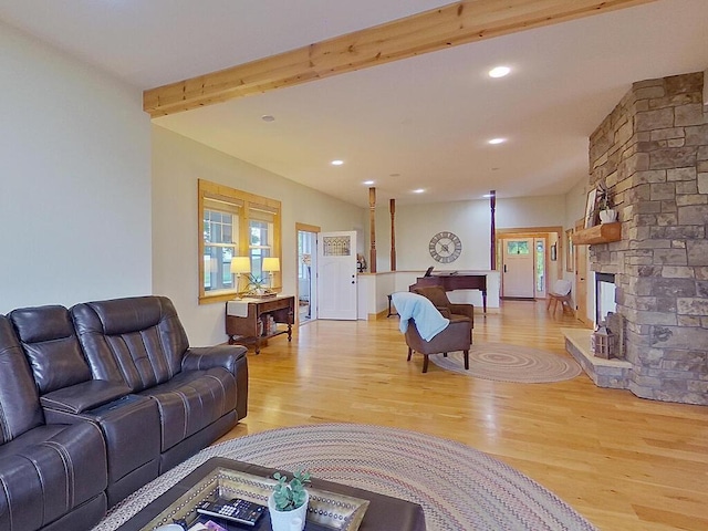 6828 Rhoades Ave SW, Cokato, MN 55321 - living area with light wood finished floors, healthy amount of natural light, a stone fireplace, recessed lighting, and beam ceiling