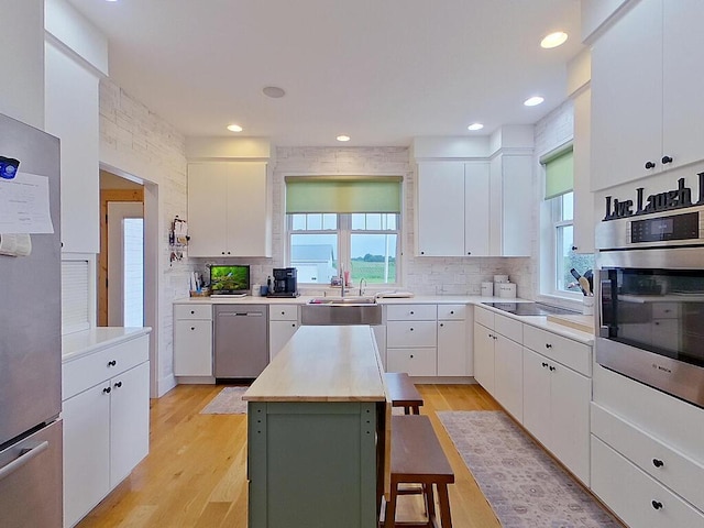 6828 Rhoades Ave SW, Cokato, MN 55321 - kitchen featuring appliances with stainless steel finishes, decorative backsplash, white cabinetry, and recessed lighting