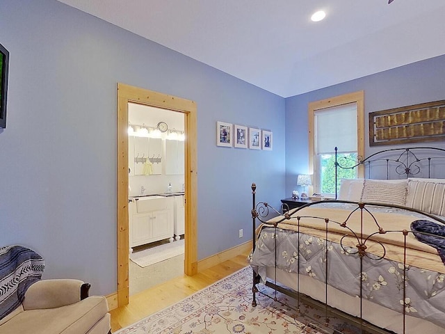 6828 Rhoades Ave SW, Cokato, MN 55321 - bedroom featuring wood finished floors, ensuite bathroom, and recessed lighting