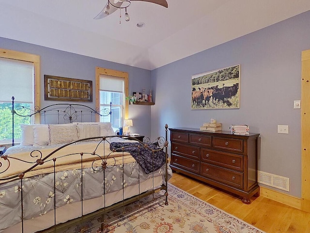 6828 Rhoades Ave SW, Cokato, MN 55321 - bedroom featuring light wood-style flooring, multiple windows, and ceiling fan