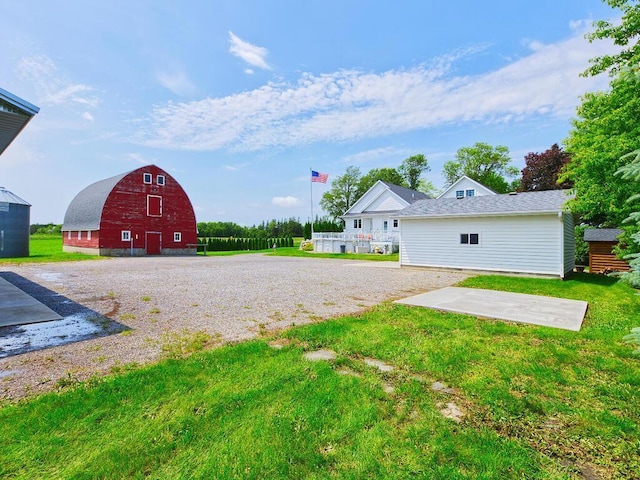 6828 Rhoades Ave SW, Cokato, MN 55321 - view of grassy yard with a barn and an outbuilding