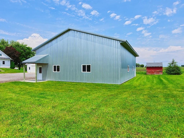 6828 Rhoades Ave SW, Cokato, MN 55321 - view of property exterior with a yard, an outdoor structure, a garage, and driveway