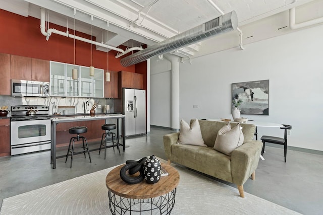 2929 Chicago Ave Unit 1208, Minneapolis, MN 55407 - living room featuring concrete flooring and a towering ceiling