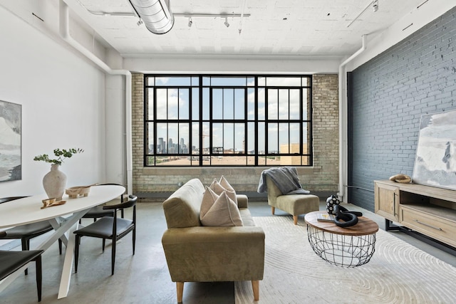 2929 Chicago Ave Unit 1208, Minneapolis, MN 55407 - living room with concrete flooring, brick wall, track lighting, and plenty of natural light