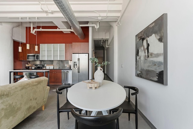 2929 Chicago Ave Unit 1208, Minneapolis, MN 55407 - dining space with finished concrete floors and a towering ceiling