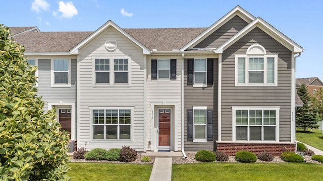 8312 Jonquil Ln N, Maple Grove, MN 55369 - townhome / multi-family property featuring a front yard, brick siding, and roof with shingles