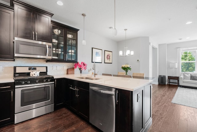 8312 Jonquil Ln N, Maple Grove, MN 55369 - kitchen featuring appliances with stainless steel finishes, a peninsula, a chandelier, dark wood-type flooring, and light countertops